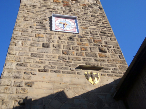 Watch tower, town clock and state crest.